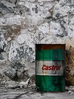 Burnt Prints: Green and white oil barrel with red Castrol logo on white background