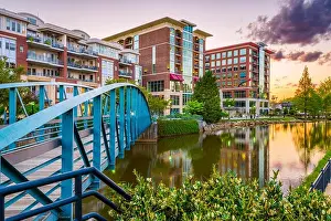 Greenville, South Carolina, USA downtown cityscape on the Reedy River at dusk