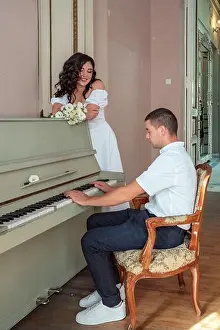 Pianist Prints: The groom plays on the piano. Grand piano wedding bride and groom music
