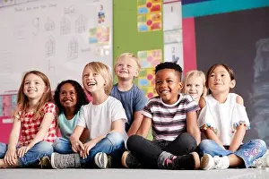 Pupils Prints: Group Of Elementary School Pupils Sitting On Floor In Classroom