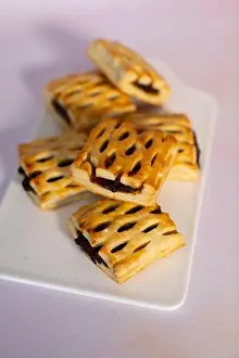 Confectionery Prints: A group of golden brown lattice puff pastries filled with dark fruit jam or mincemeat