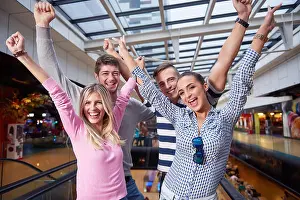 Group Of Prints: group of happy friends in shopping mall have fun