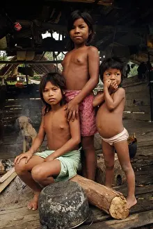 A group of indigenous Colombian children pose in their simple house in a village near the town of Nuqui Colombia