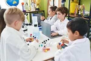 Concentrate Prints: Group of kids scientists students using laptop holding molecules at laboratory classroom