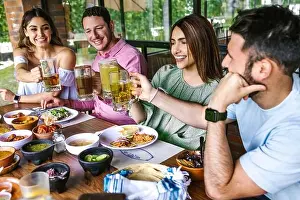 Latina Prints: Group of latin friends eating traditional mexican food in restaurant terrace in Mexico Latin America