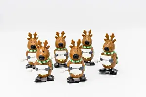 Yuletide Prints: Group of six novelty plastic wind-up models of Santa's reindeer holding signs with their names