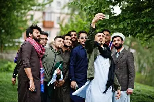 Mans Prints: Group of pakistani man wearing traditional clothes salwar kameez or kurta making selfie on mobile phone