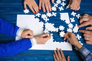 Finding Prints: Group of people doing puzzle on table