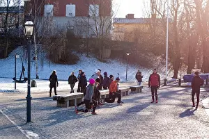 Runners Prints: Group of people outdoors in cold winter warming up before going on a group run in Stockholm