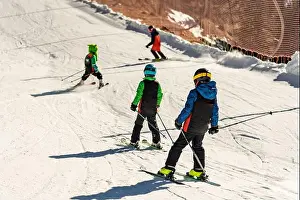 Dolomites Prints: Group of people skiing in the mountains on a sunny winter day