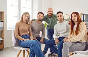 Caring Prints: Group portrait of people, friends gathered together sitting close for communication