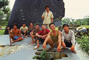 Tailplane Prints: A group of smiling park workers on the tail plane of a crashed US B 52 bomber at Lenin Park in the northern capital of