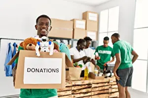 Volunteering Prints: Group of young african american volunteers working at charity center