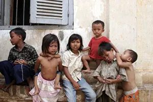 Gloom Prints: A group of young children too poor to attend school while away their day at a Buddhist temple in Phnom