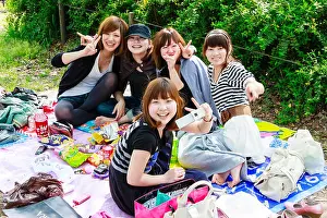 Sits Prints: Group of five young Japanese women sitting in park having a cherry blossom party