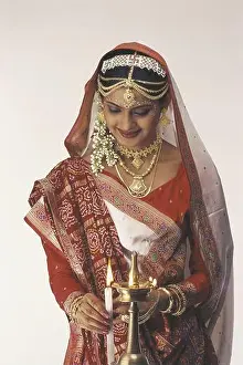 Contentment Prints: Gujarati Bride Dressed In Traditional Bridal Costume, Mid Shot Lighting A Lamp MR 121