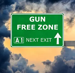 Motivational Prints: GUN FREE ZONE road sign against clear blue sky