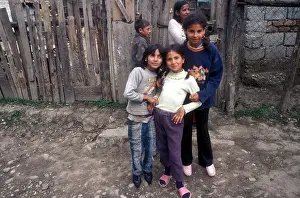 Five Gypsy children pose in front of a wooden fence in their village of Soard [Transylvania], Romania