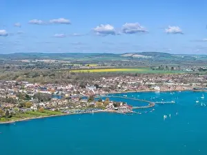 Hampshire town of Emsworth from above. View looking East along the coastline. Farmland and hills beyond the town