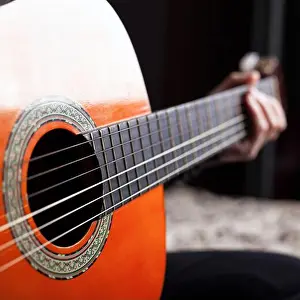 Music Instrument Prints: hand on fretboard acoustic guitar orange color