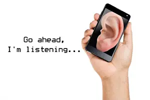 Spying Prints: hand holding smartphone with human ear listening displayed on it isolated