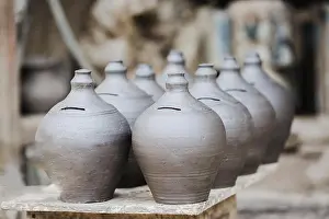 Piggy Prints: Handmade clay piggy bank on natural background in pottery square bhaktapur nepal