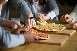 Customers Prints: Hands of diverse people taking pizza slices dining in pizzeria