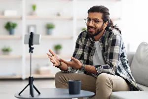 Empty Space Prints: handsome arab guy with glasses blogger streaming from home