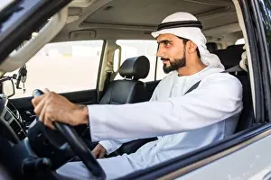 Handsome arabic man driving a car