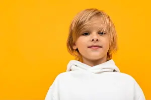 Offspring Prints: Handsome boy in white hoodie smiles and gesticulates isolated on orange background