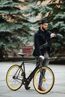 Biking Prints: Handsome hipster enjoying a bike ride and checking time on his watch