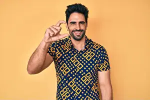 Latino Prints: Handsome hispanic man with beard wearing 80s disco style shirt smiling