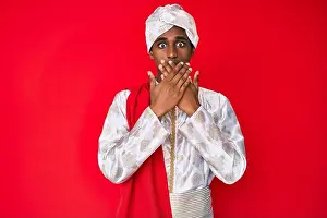Saree Prints: Handsome indian man wearing tradition sherwani saree clothes shocked covering mouth with hands for mistake