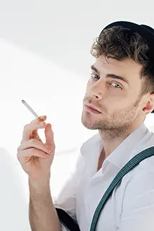 Nicotine Prints: handsome man holding cigarette and looking at camera