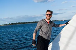 Yachting Prints: Handsome man traveling by yacht
