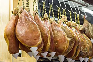 Iberian Prints: hanging pork legs hamon in market