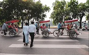 Today Prints: Hanoi, Vietnam - Oct 3, 2013. Tourists take a tour around Hoan Kiem Lake by cyclo