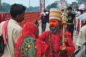 Orange Color Prints: Hanuman Sadhu blessing pilgrims at Har Ki Pairi ghat by the Ganges river