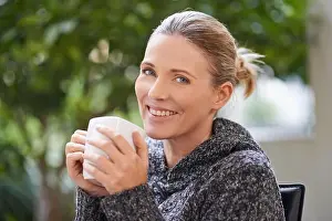Good Looking Prints: Happiness is only a sip away. Shot of an attractive mature woman enjoying a hot drink at a spa