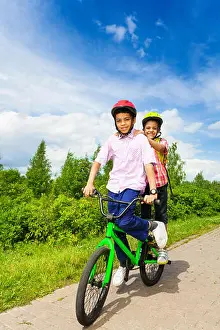 Mates Prints: Two happy boys riding same bike both standing