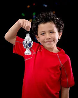 Ramadan Prints: Happy Child with Ramadan Lantern on Defocused Night Lights Background