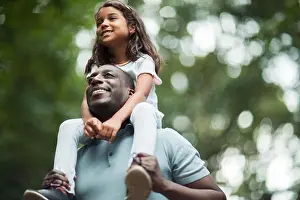 Mixed Race Prints: Happy father carrying daughter on shoulders