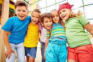 Embracing Prints: Happy friends looking at camera on playground outdoors