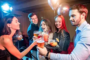 Glamorous Prints: happy group of friends laugh and drink and have fun togeher in karaoke bar