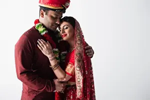 Bridegroom Prints: happy indian couple of husband and wife in traditional clothing hugging isolated on grey