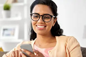 South Asian Prints: happy indian woman using smartphone at home