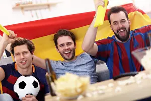 Cheering Prints: Happy male friends cheering and watching sports on tv