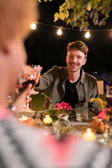 Weekend Activities Prints: Happy man toasting wine glass at dinner garden party