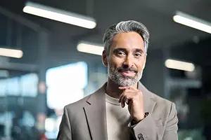 Investor Prints: Happy middle aged older business man looking at camera in office, portrait