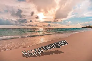 Happy new year written in the sky. Artistic summer beach holiday with new years eve concept